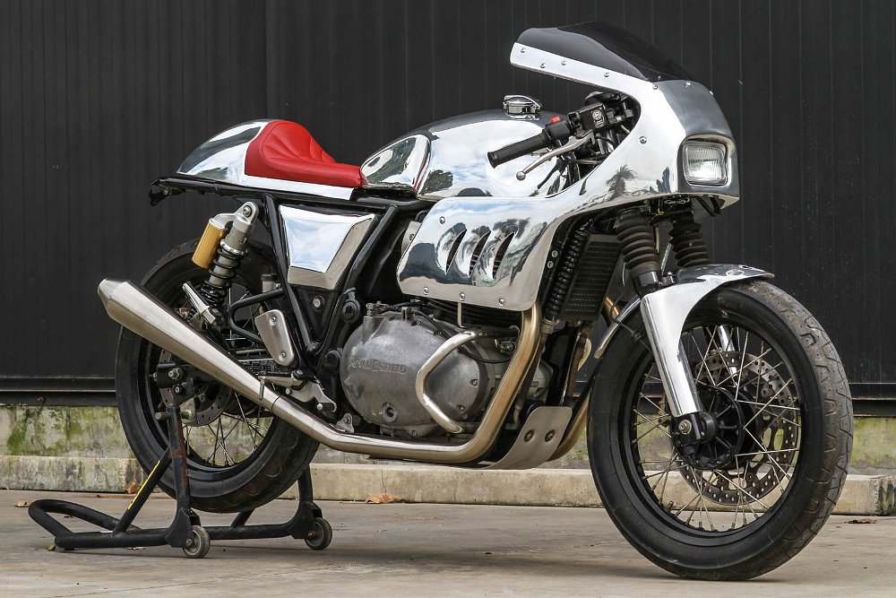 racy custom motorcycle with a chrome half-fairing, tank, and tail section and a red seat