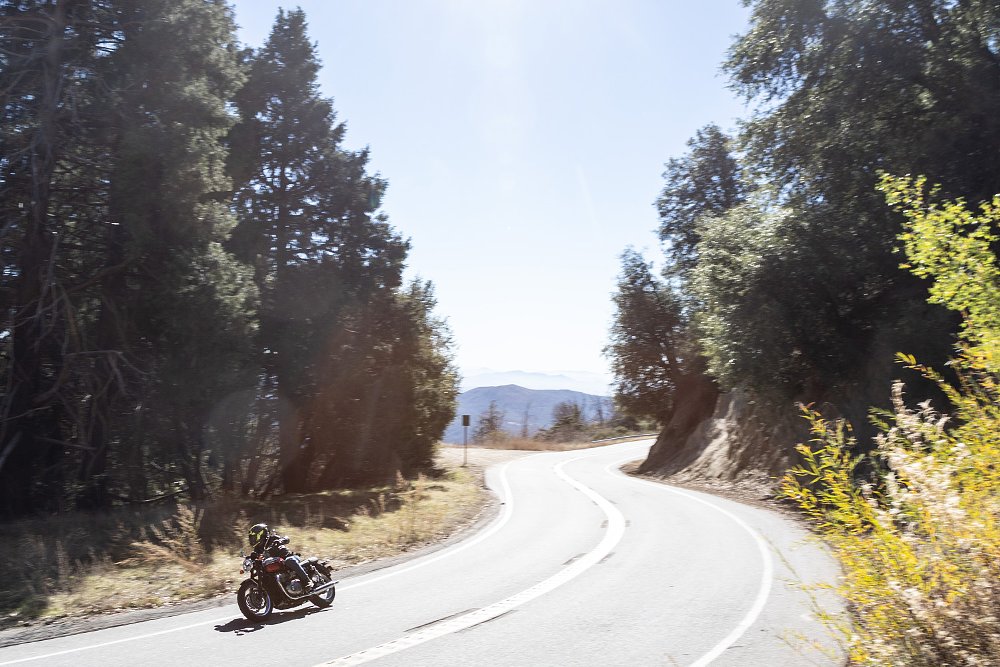 Dustin rides the T120 through a corner on Palomar Mountain Road.