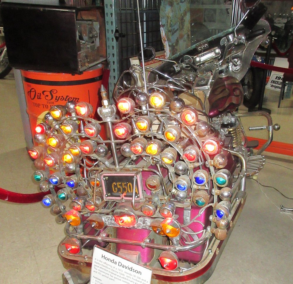 rear view of a motorcycle in the museum with a large array of colored lights on the back